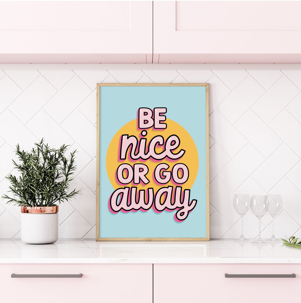 Colorful wall art print with the quote "Be Nice or Go Away" against a vibrant background.