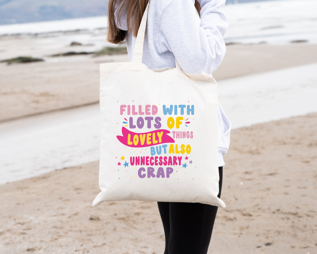 Colourful Tote Bag, with the quote "Filled with Lots of Lovely Things but Also Unnecessary Crap" in pink, purple, blue and yellow writing