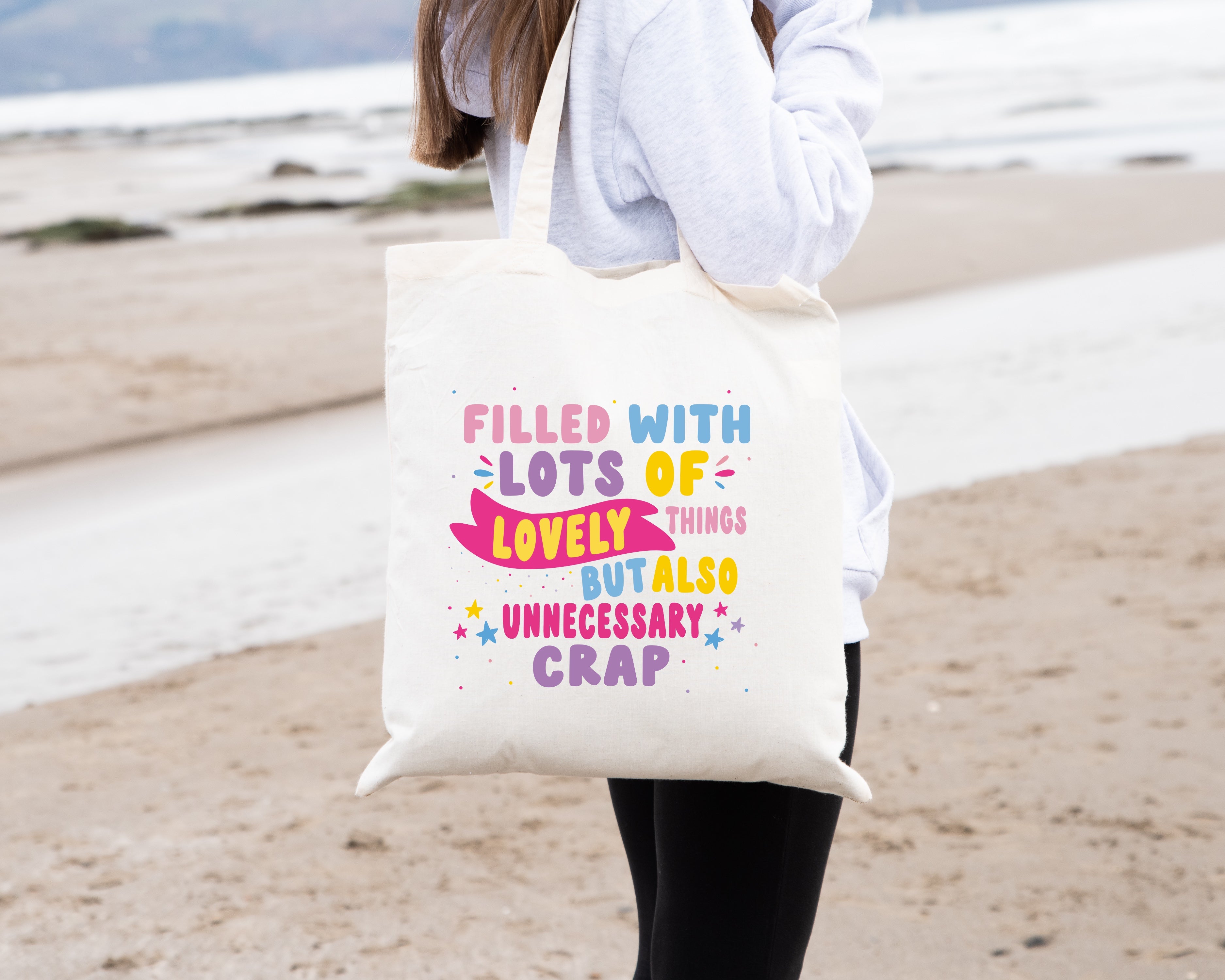 Colourful Tote Bag, with the quote "Filled with Lots of Lovely Things but Also Unnecessary Crap" in pink, purple, blue and yellow writing