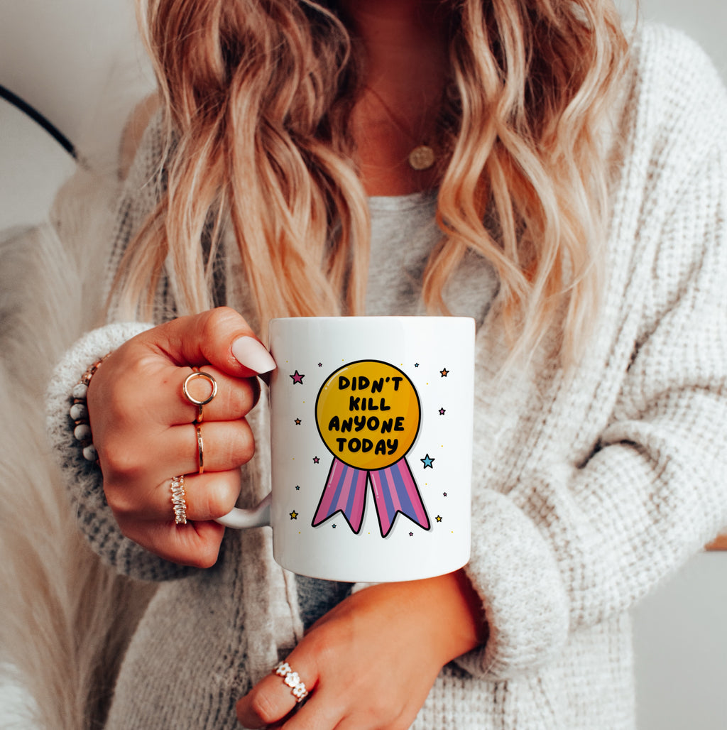 "Joyful person holding 'Didn't Kill Anyone Today' Mug, embracing daily victories."