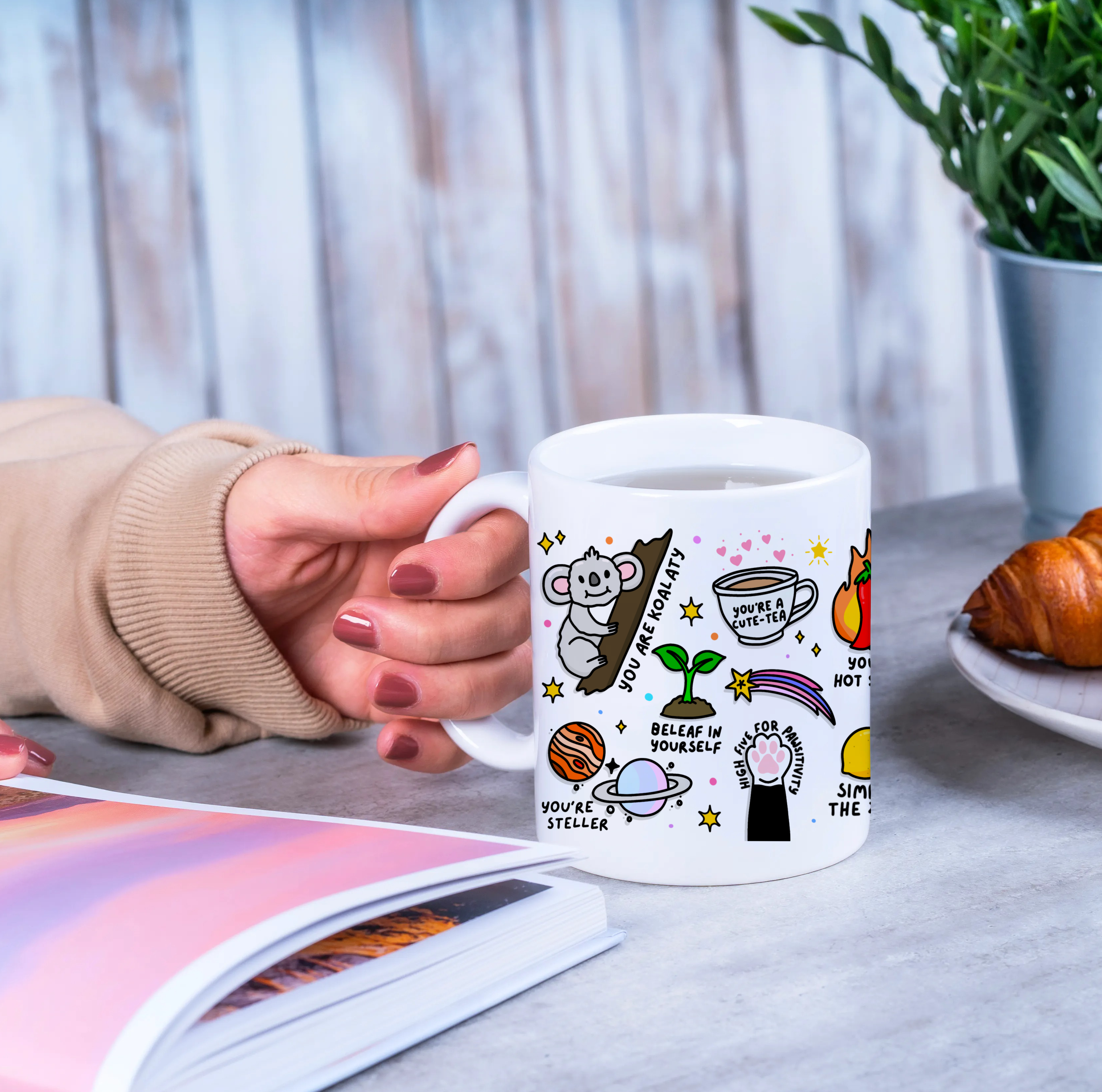 "Joyful Sip - Close-up of someone's hands wrapped around a Positivity Mug, filled with inspiration and warmth."