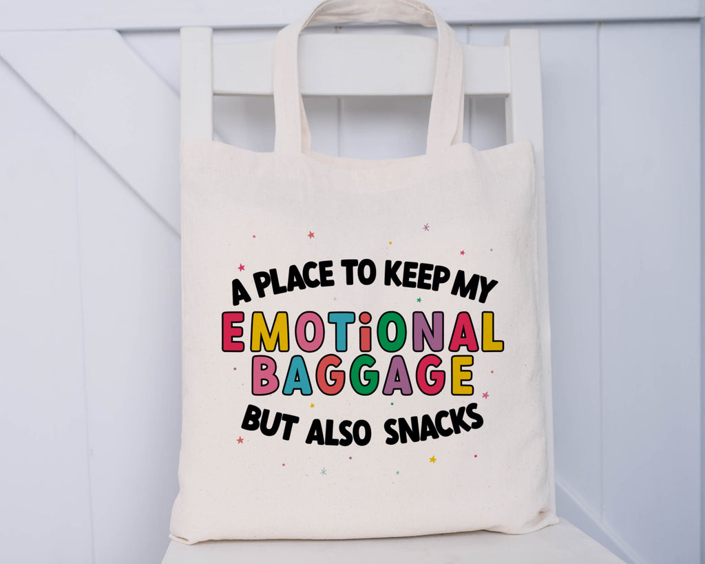 Natural coloured tote bag with the phrase 'a place to keep my emotional baggage but also snacks'
